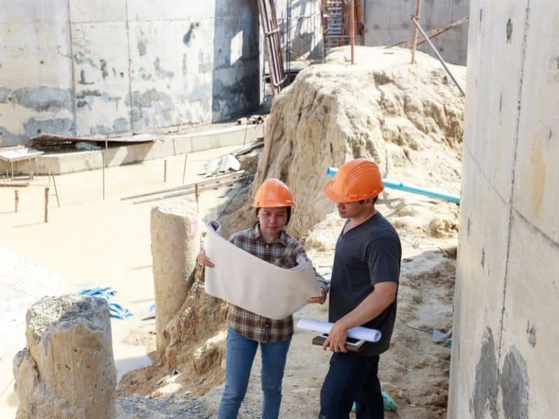 Survey and construction professionals reviewing commercial site plans during an ALTA survey and pre-development assessment.