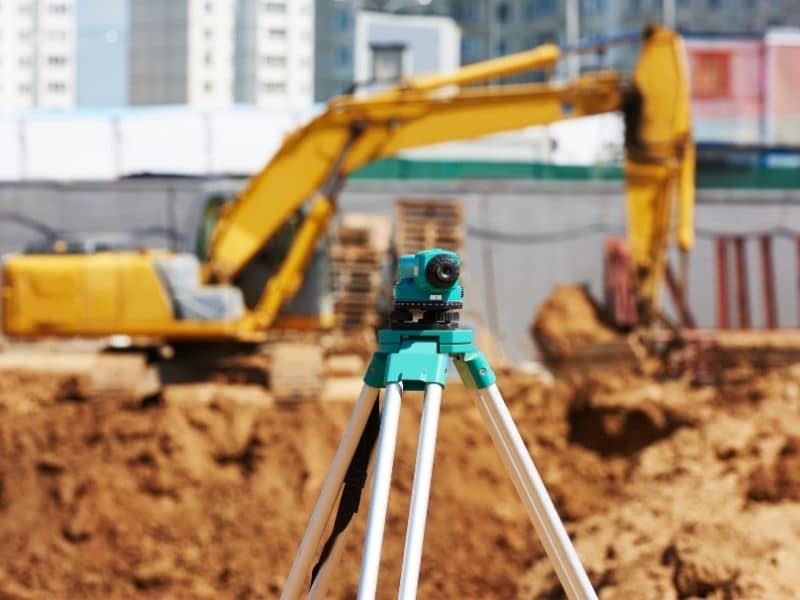 Construction survey equipment set up on a commercial job site to support layout and coordination during phased development.