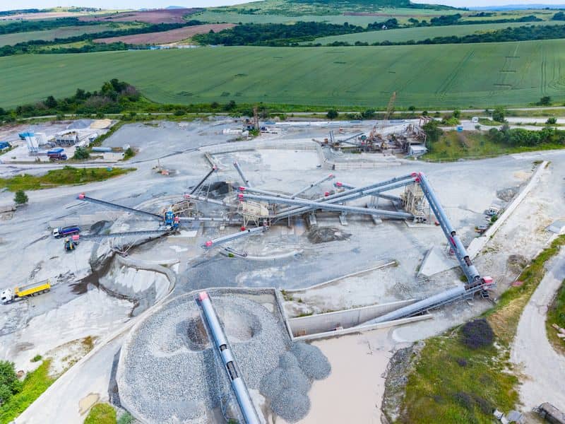 Drone land surveying view of stockpiles at an active material yard in Dallas, Texas.