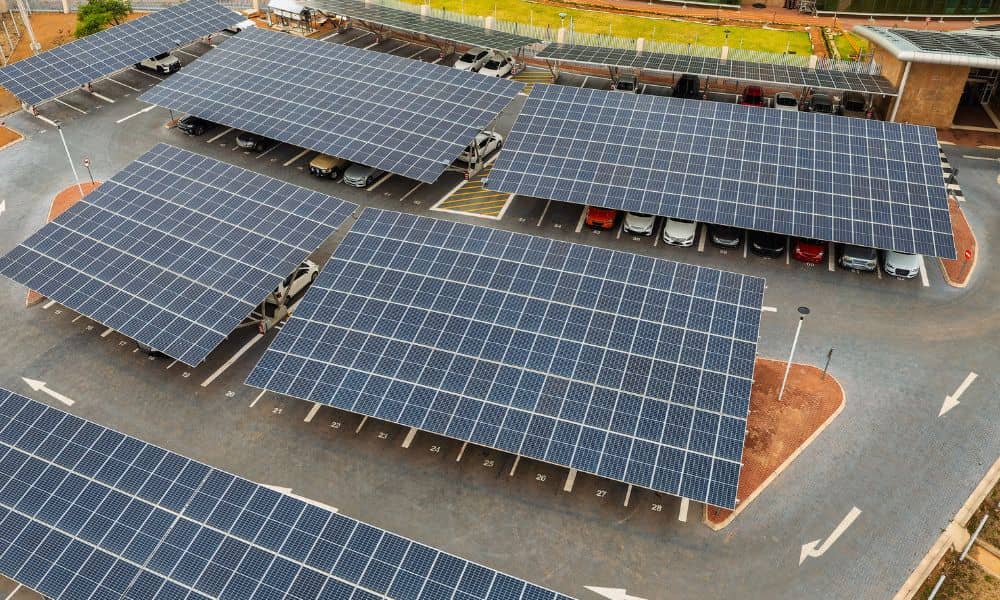 Aerial view of a large parking lot with solar panel canopies, parking spaces, and drive aisles, illustrating the site layout examined in an aerial survey